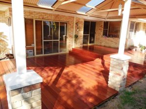 Spacious wooden deck with a covered Perth patios area attached to a brick house. Phoenix Patios, Cottages and Granny Flats in Perth